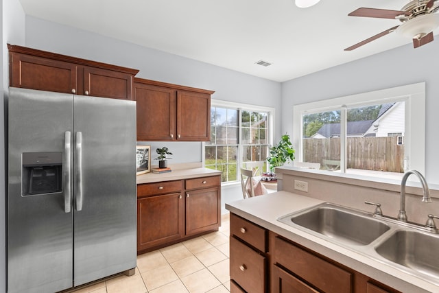 kitchen with ceiling fan, sink, stainless steel fridge with ice dispenser, and light tile patterned floors