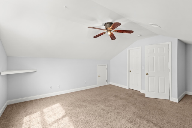 additional living space with lofted ceiling, carpet flooring, and ceiling fan