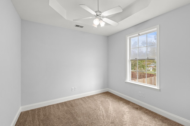 carpeted spare room with ceiling fan