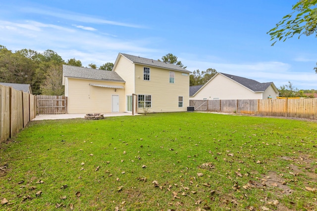 rear view of house featuring a lawn, central AC unit, and a patio area