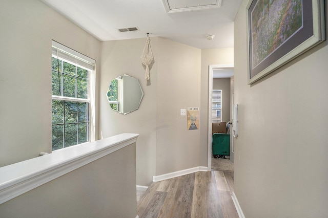 corridor with hardwood / wood-style floors