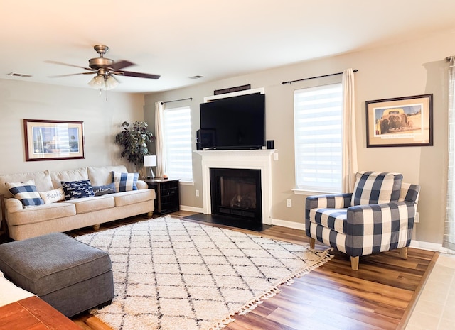 9229 N Moreto Cir, Summerville, SC 29485 - living area featuring a ceiling fan, wood finished floors, baseboards, and a fireplace with flush hearth