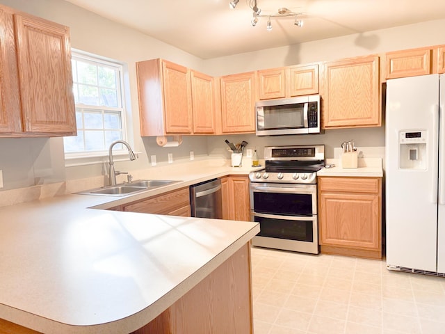 9229 N Moreto Cir, Summerville, SC 29485 - kitchen featuring appliances with stainless steel finishes, light brown cabinets, a sink, light countertops, and a peninsula
