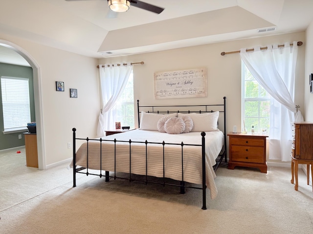 9229 N Moreto Cir, Summerville, SC 29485 - bedroom with light carpet, multiple windows, arched walkways, and baseboards