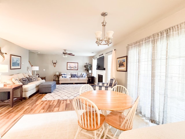 9229 N Moreto Cir, Summerville, SC 29485 - dining space featuring light wood-style floors, a ceiling fan, and a chandelier