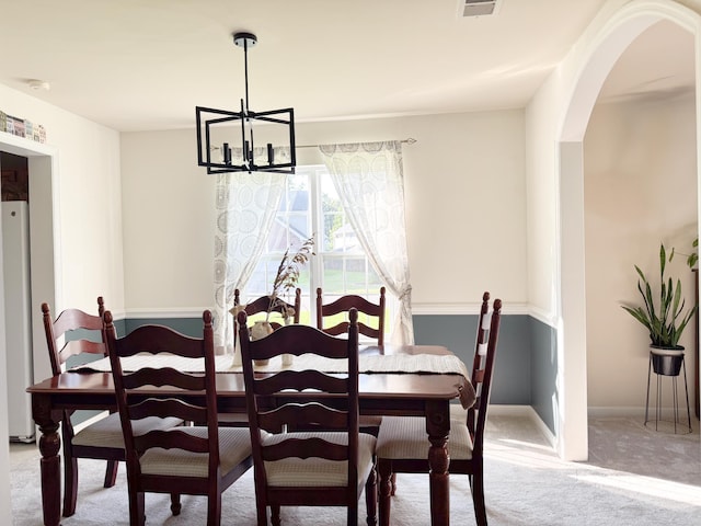 9229 N Moreto Cir, Summerville, SC 29485 - dining room featuring carpet flooring, arched walkways, a chandelier, and baseboards