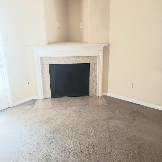 room details with a fireplace with flush hearth and baseboards