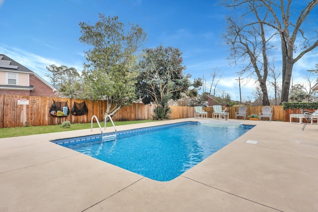 view of swimming pool with a fenced in pool, a fenced backyard, and a patio area