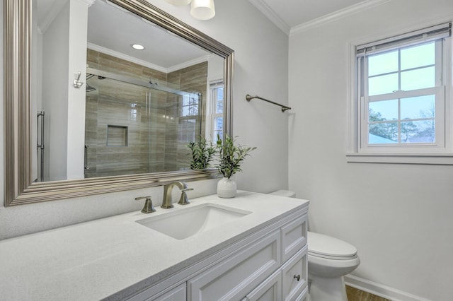 bathroom with vanity, baseboards, a stall shower, ornamental molding, and toilet