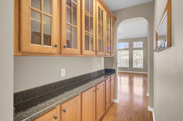 interior space featuring dark stone countertops and light hardwood / wood-style flooring