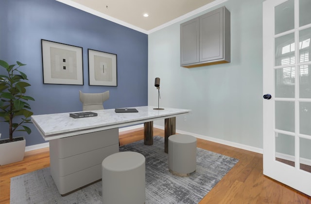 office area with light wood-type flooring and ornamental molding