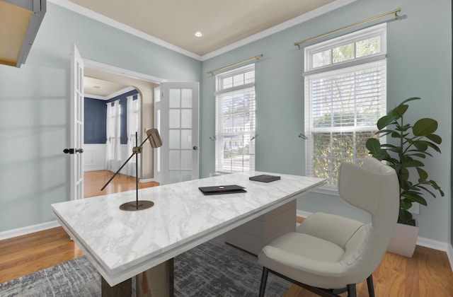 dining area featuring french doors, ornamental molding, and light wood-type flooring