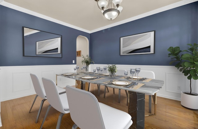 dining space featuring a chandelier, crown molding, and wood-type flooring