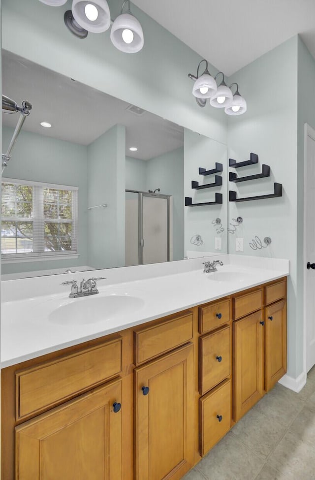 bathroom featuring tile patterned flooring, vanity, and an enclosed shower