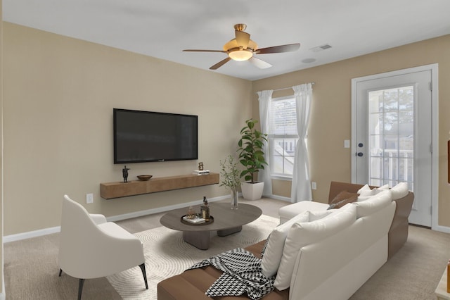 living room featuring ceiling fan and light colored carpet