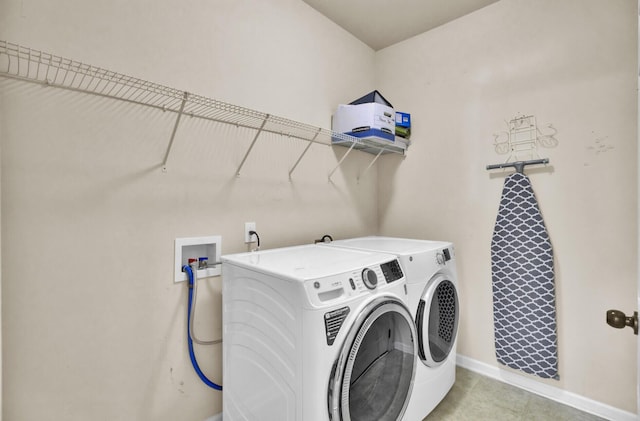 laundry room with washing machine and clothes dryer