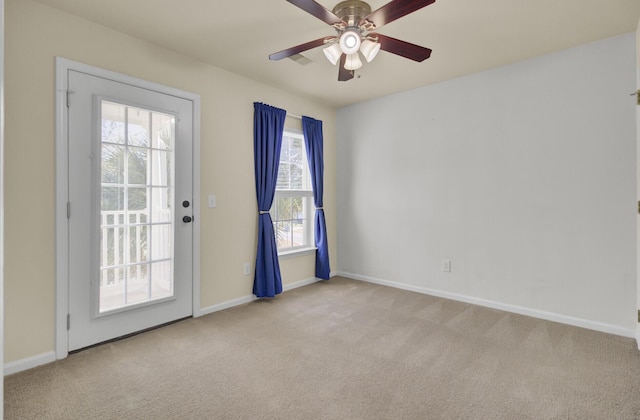 spare room featuring ceiling fan and light carpet