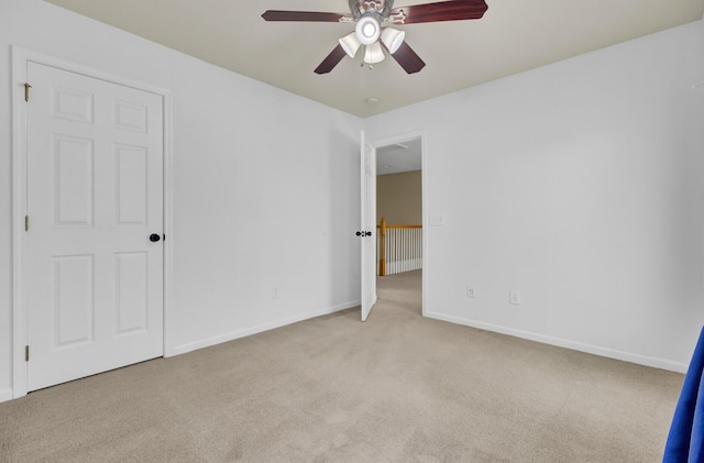 unfurnished bedroom featuring ceiling fan and light colored carpet