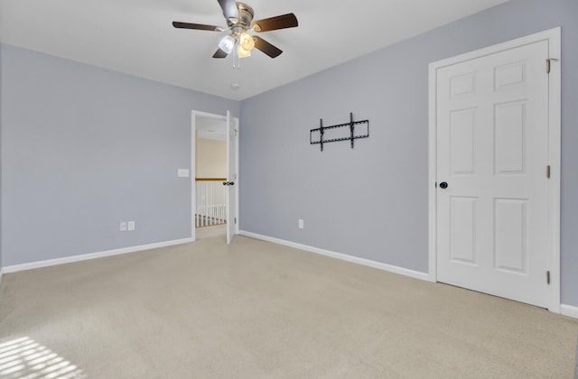 unfurnished bedroom featuring light carpet and ceiling fan