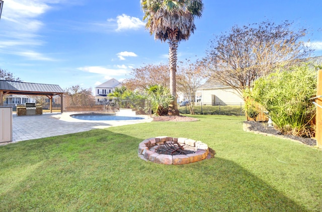 view of yard featuring area for grilling, a patio, and an outdoor fire pit