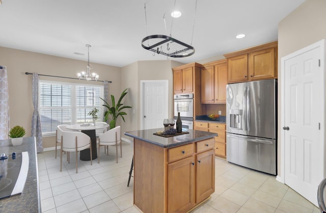 kitchen with stainless steel appliances, pendant lighting, light tile patterned floors, an inviting chandelier, and a center island