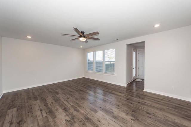 spare room with baseboards, recessed lighting, ceiling fan, and dark wood-style flooring