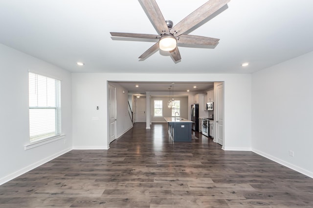 unfurnished living room featuring baseboards, recessed lighting, dark wood-type flooring, and ceiling fan