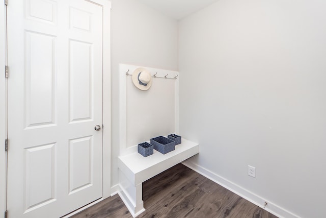 mudroom featuring baseboards and dark wood-style floors