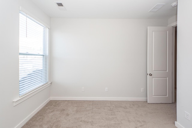 spare room featuring carpet flooring and baseboards