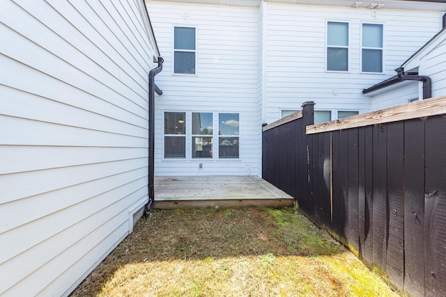 back of property with fence and a deck