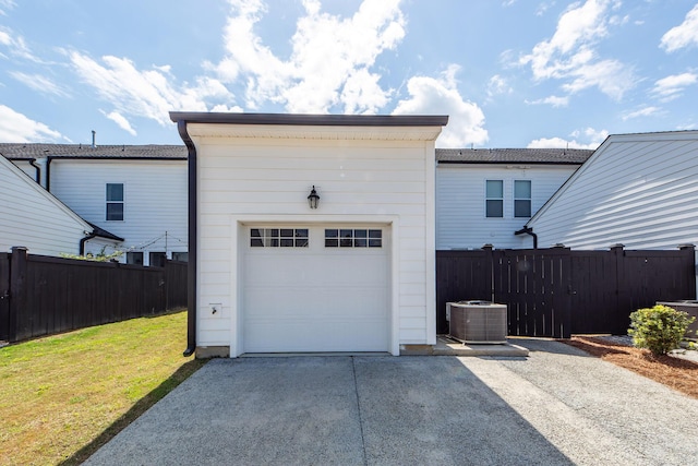 garage with aphalt driveway and fence