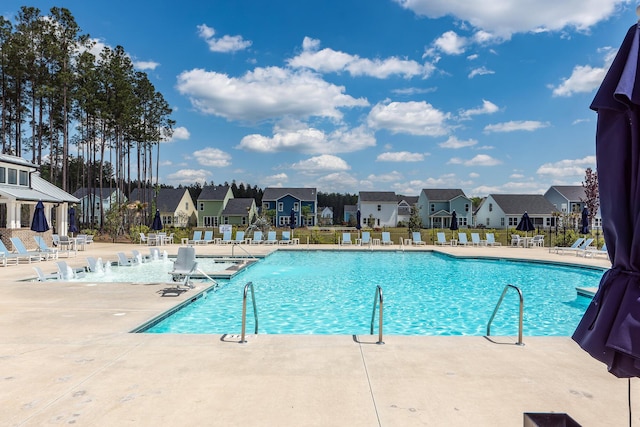 pool featuring a residential view, fence, and a patio area