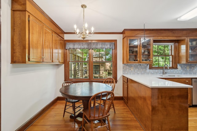 712 Wakendaw Blvd, Mount Pleasant, SC 29464 - dining space with a chandelier, light wood-style flooring, and crown molding