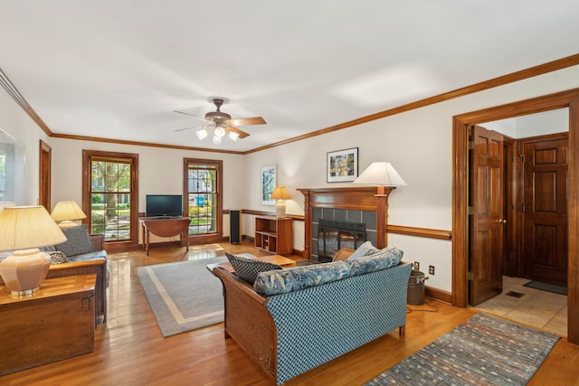 712 Wakendaw Blvd, Mount Pleasant, SC 29464 - living area featuring wood finished floors, a ceiling fan, a fireplace, and ornamental molding