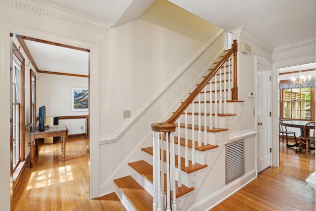 712 Wakendaw Blvd, Mount Pleasant, SC 29464 - staircase with hardwood / wood-style floors, a chandelier, and crown molding