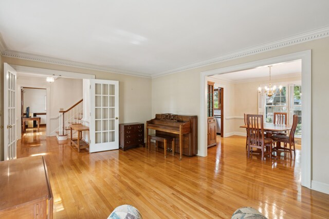 712 Wakendaw Blvd, Mount Pleasant, SC 29464 - living area with french doors, a chandelier, light wood-style flooring, crown molding, and stairway