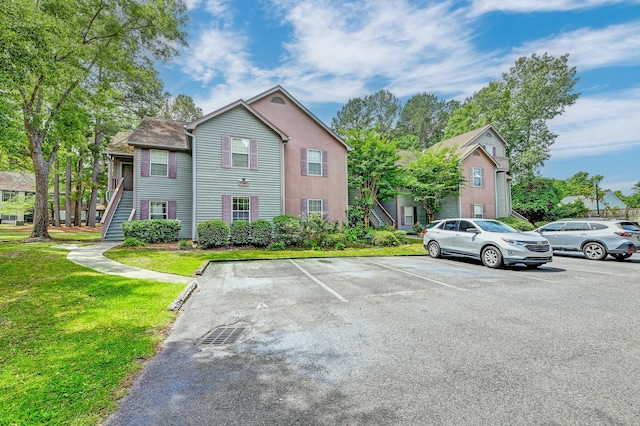 7955 Timbercreek Ln Unit 1807, North Charleston, SC 29418 - view of front facade featuring stairway, uncovered parking, and a front lawn