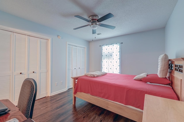 7955 Timbercreek Ln Unit 1807, North Charleston, SC 29418 - bedroom featuring multiple closets, dark wood-style flooring, a textured ceiling, baseboards, and ceiling fan
