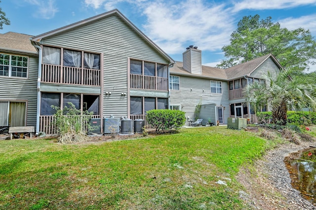 7955 Timbercreek Ln Unit 1807, North Charleston, SC 29418 - back of property featuring a chimney, a lawn, and central AC