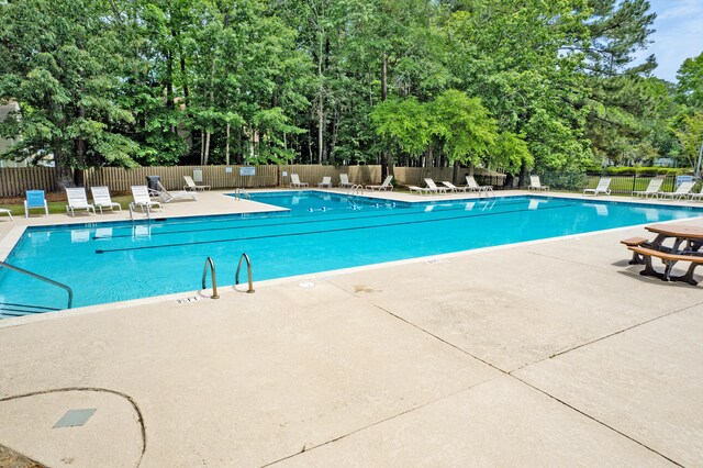 7955 Timbercreek Ln Unit 1807, North Charleston, SC 29418 - community pool featuring fence, a patio, and view of wooded area
