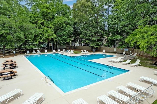 7955 Timbercreek Ln Unit 1807, North Charleston, SC 29418 - community pool featuring fence, a patio area, and view of wooded area