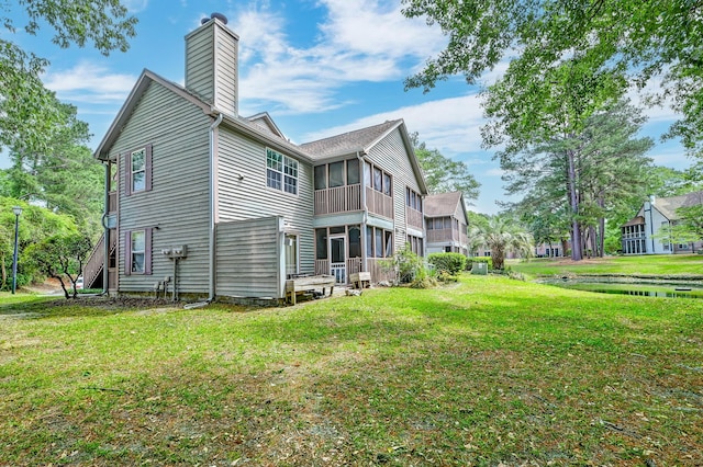 7955 Timbercreek Ln Unit 1807, North Charleston, SC 29418 - view of side of property with a chimney, a lawn, and a sunroom