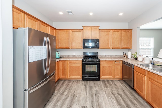 kitchen featuring black appliances, visible vents, light countertops, and light wood-style floors