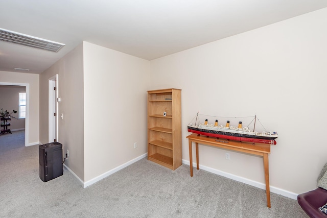 interior space featuring baseboards, visible vents, and carpet flooring