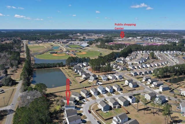 drone / aerial view with a water view and a residential view