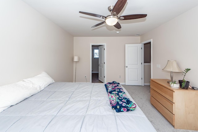 bedroom with light carpet, ceiling fan, and baseboards