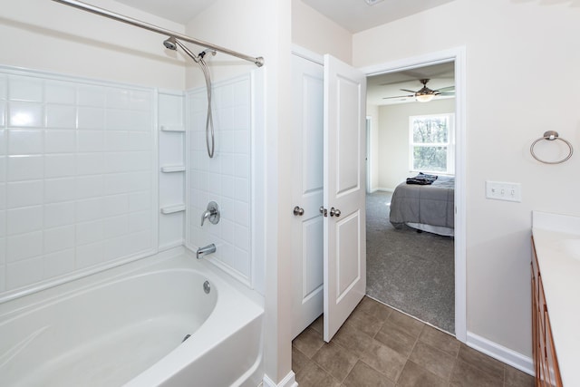 full bath with  shower combination, tile patterned flooring, vanity, and baseboards