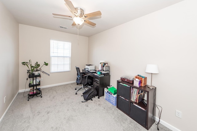 home office with carpet, visible vents, ceiling fan, and baseboards