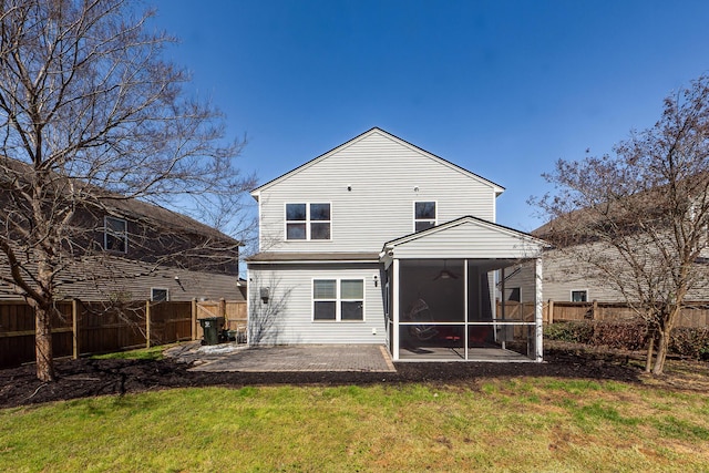 back of property featuring a lawn, a sunroom, a fenced backyard, ceiling fan, and a patio area