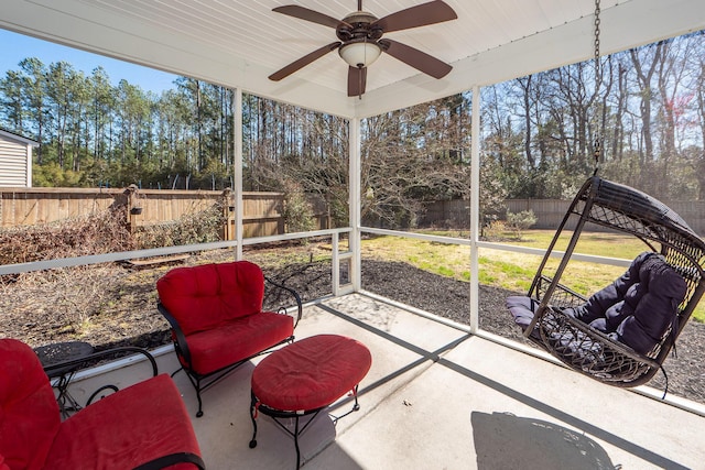 sunroom / solarium featuring ceiling fan